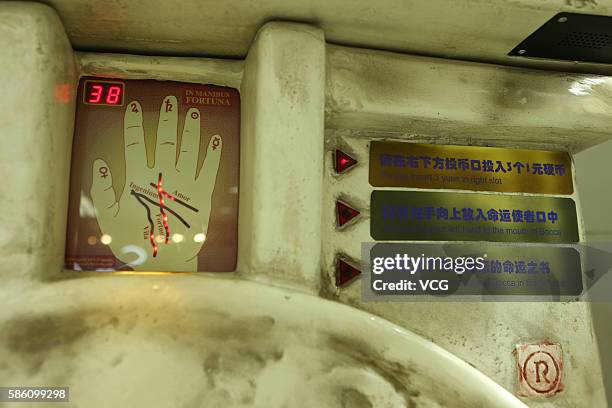 Screen to put hand and step guidance are seen as parts of a fortune-telling machine at an underground mall in People's Square on August 4, 2016 in...