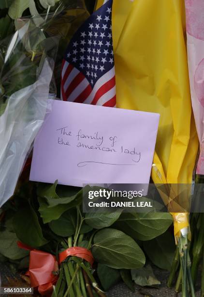 An envelope addressed to 'The family of the American lady' is pictured amongst floral tributes left near a crime scene in London's Russell Square on...