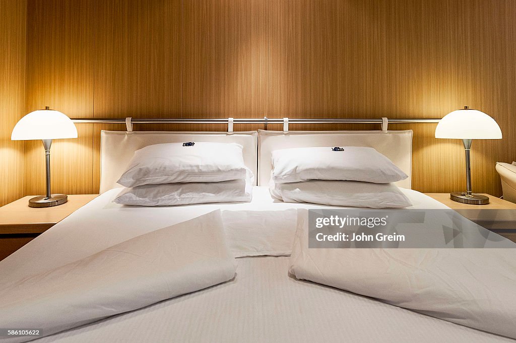 Freshly turned bed of a cruise ship cabin...