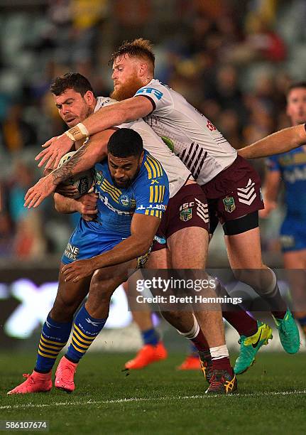 Michael Jennings of the Eels is tackled during the round 22 NRL match between the Parramatta Eels and the Manly Sea Eagles at Pirtek Stadium on...