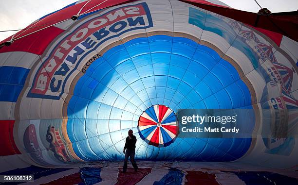 Hot air balloons are prepared to take to the skies at a preview flight to launch next week's Bristol International Balloon Fiesta on August 5, 2016...