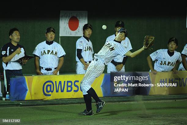 Shoki Koyama of Japan drops a catch in the foul territory in the top half of the eighth inning in the super round game between Japan and USA during...