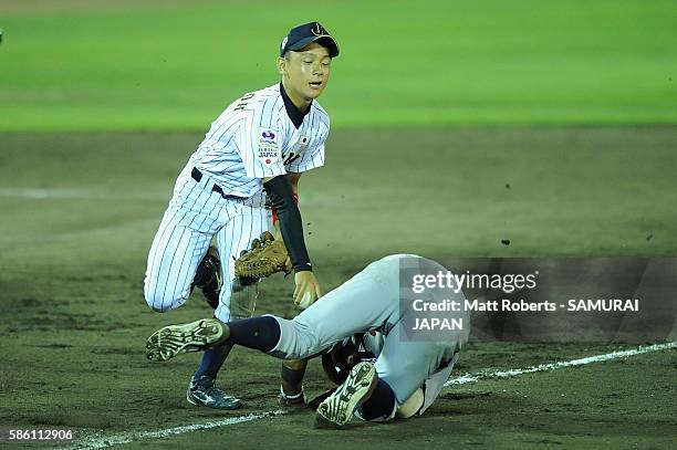 Daiki Kondo of Japan attempts to tag out Anthony Volpe of the USA in the top half of the eighth inning in the super round game between Japan and USA...