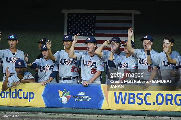 Players of the USA react in the dugout in the bottom half of the second inning in the super round game between Japan and USA during The 3rd WBSC U-15...