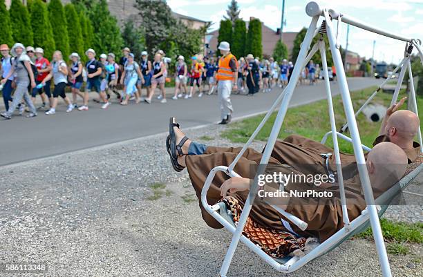 Two monks watch passing pilgrims by Bratkowice, during the 1st 32km stage of the Rzeszow-Kamionka as the 32nd annual pilgrimage to Jasna Gora kicked...