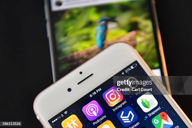 The Instagram app logo is displayed next to an "Instagrammed" image on another iPhone on August 3, 2016 in London, England.