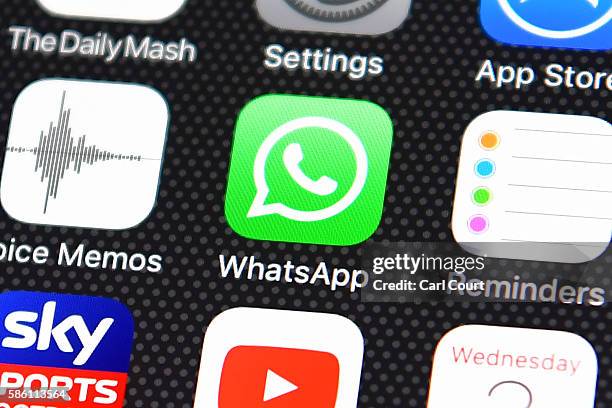 The Whatsapp app logo is displayed on an iPhone on August 3, 2016 in London, England.