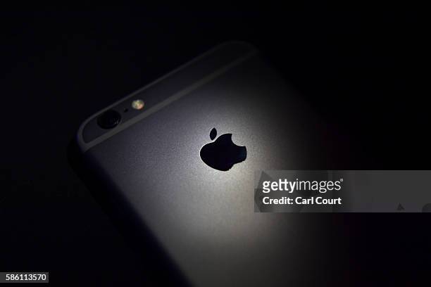The Apple logo is displayed on the back of an iPhone on August 3, 2016 in London, England.