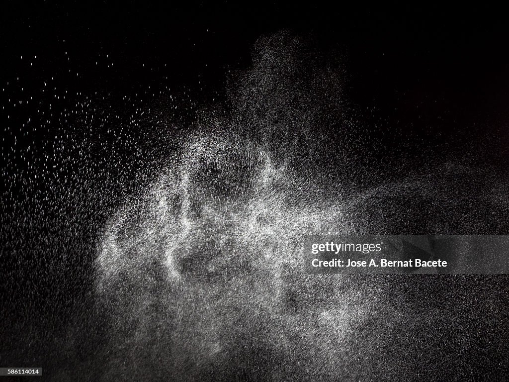 Clouds of water drops in suspension on a black bottom