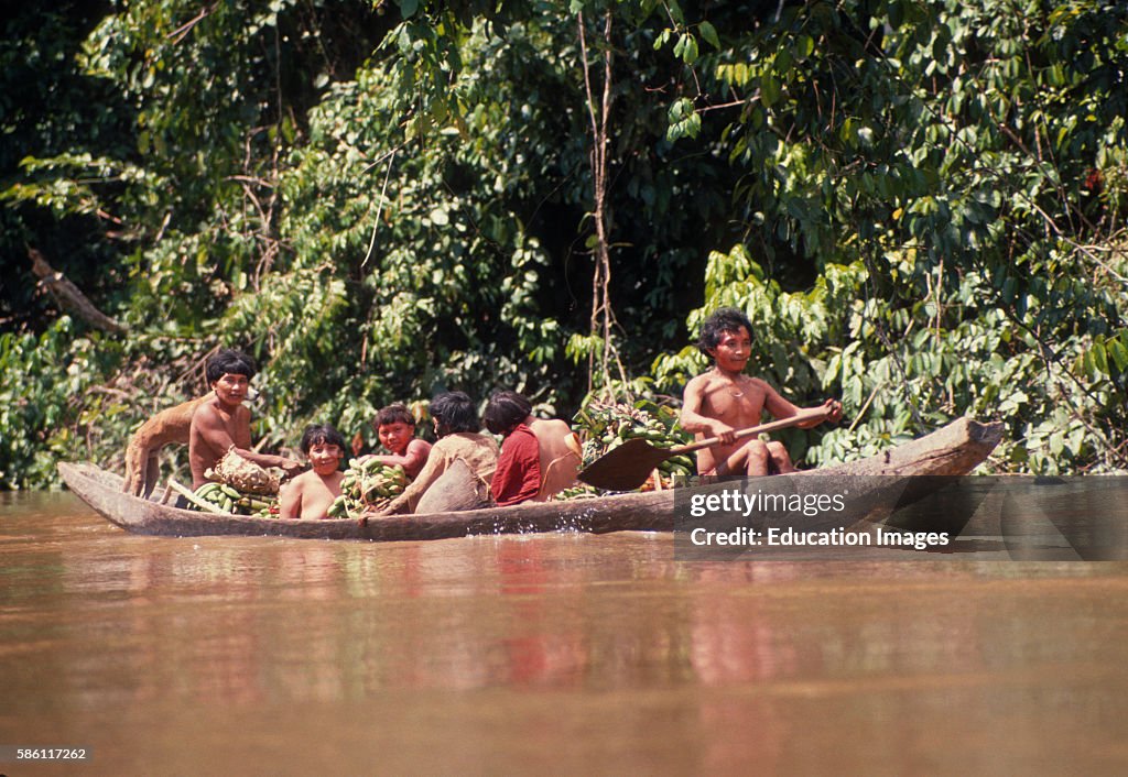 Family canoeing up Acamo River