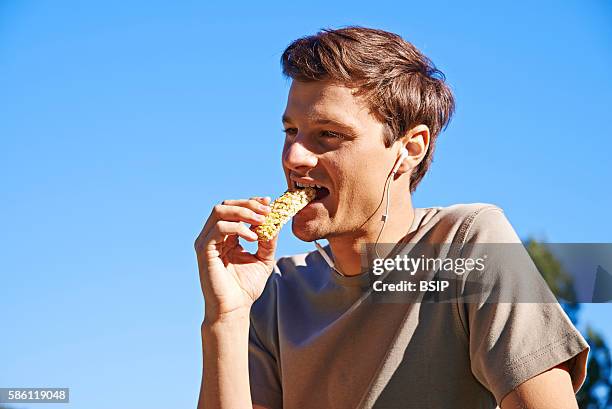 Man eating an energy bar.