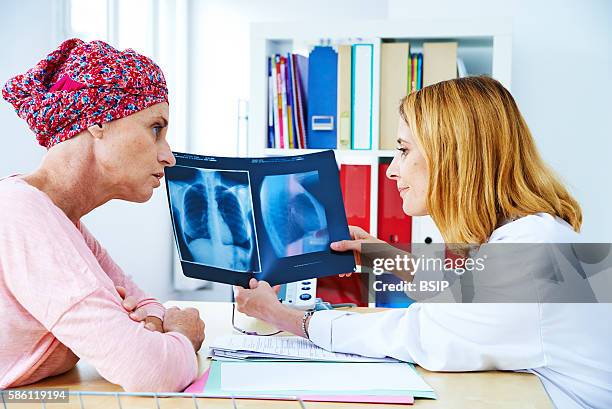 Doctor explaining to a patient the result of her chest x-ray.