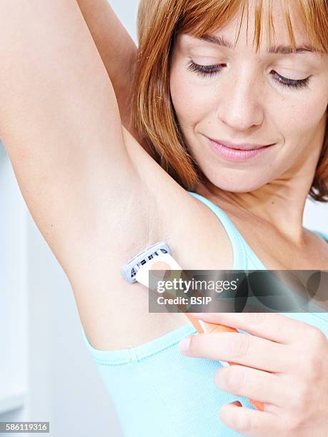 Woman shaving her armpits.