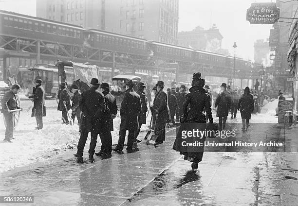 Pedestrians on Street During Blizzard, New York City, USA, circa 1899.