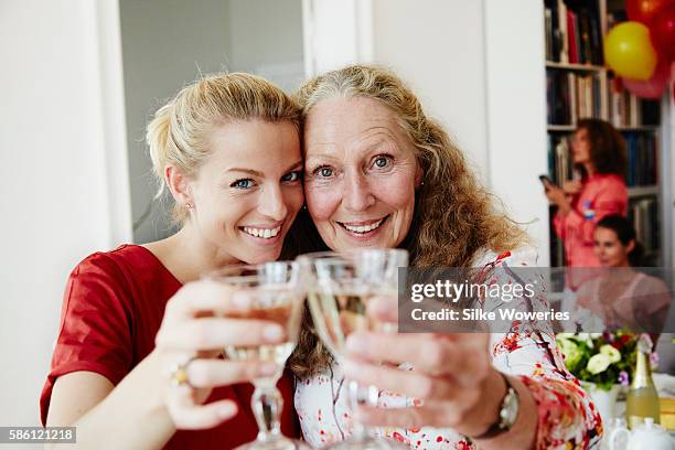 happy friends raise a glas of sparkling wine at a party - daughter birthday stock pictures, royalty-free photos & images