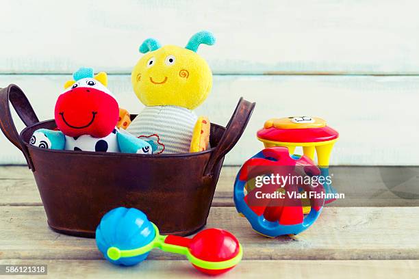 baby toys in a basket - baby rattle stock pictures, royalty-free photos & images