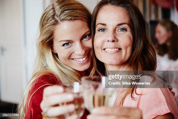happy friends raise a glas of sparkling wine at a party - 40 birthday foto e immagini stock