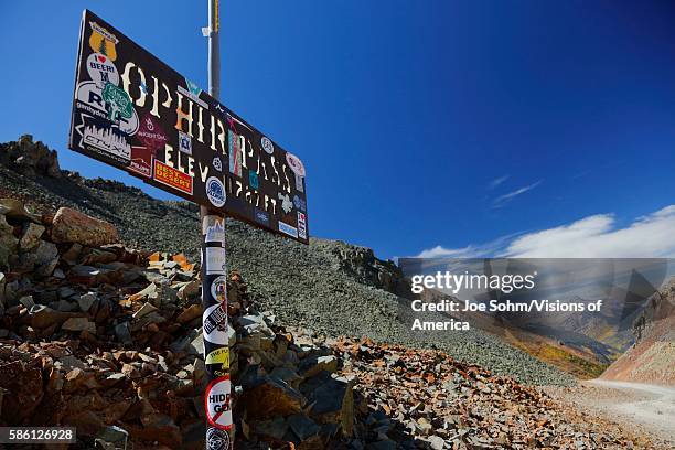 Sign reads Ophir Mountain pass at 11,789 feet elevation in San Juan Mountains In Autumn Colorado, near Telluride, Ouray and Ridgway in San Miguel...