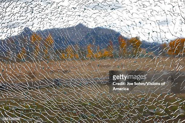 Autumn color seen threw shattered broken picture window in San Juan Mountains In Autumn Colorado, near Telluride, Ouray and Ridgway in San Miguel...