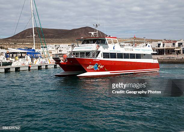 Tourist ferry boat Biosfera Express leaving the harbor Caleta de Sebo, La Isla Graciosa, Lanzarote, Canary Islands, Spain.