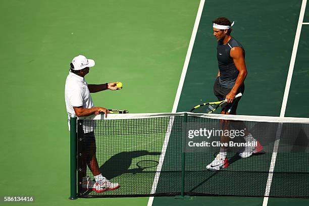 Rafael Nadal of Spain talks to coach Toni Nadal during a practice session at the Olympic Tennis Centre prior to the Rio 2016 Olympic Games on August...