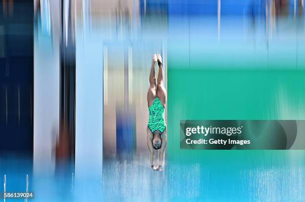 Diver enters the water during a training session at the Maria Lenk Aquatics Centre on August 5, 2016 in Rio de Janeiro, Brazil.