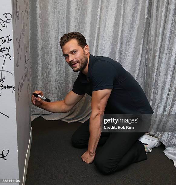 Jamie Dornan signs the wall at AOL Build at AOL HQ on August 5, 2016 in New York City.