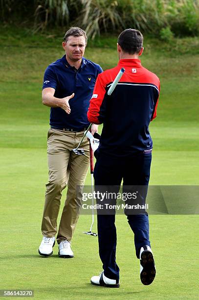 James Morrison of England shakes hands with Michael Hoey of Northern Ireland after winning their match on the green on hole 15 on day two of the...
