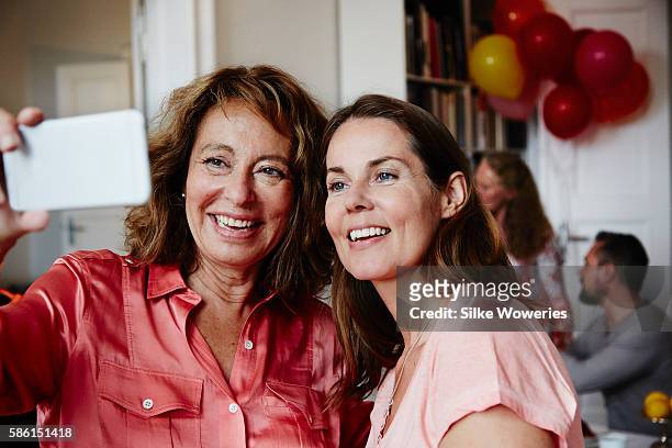 good friends taking a self-portrait with a smartphone at a party - aunyy stock pictures, royalty-free photos & images