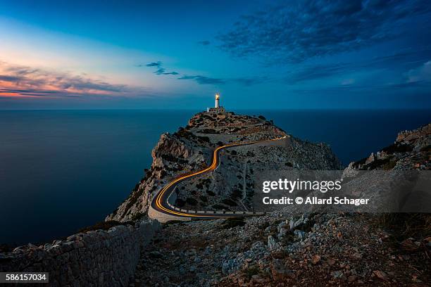 lighthouse at cap formentor mallorca at dusk - lighthouse mallorca stock pictures, royalty-free photos & images