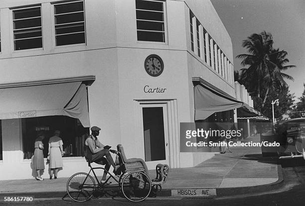 African-American pedicab operator waiting outside a Cartier jewelry store in Palm Beach, Florida, 1939. From the New York Public Library. .