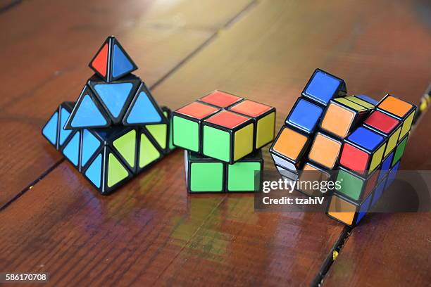 satz von drei rubiks cube - triangle instrument on white stock-fotos und bilder