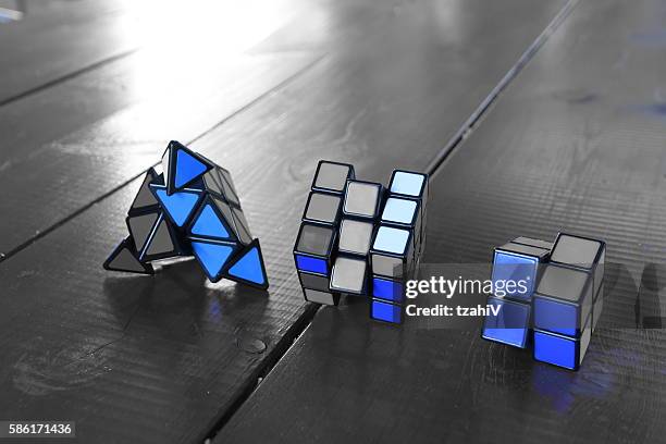 satz von drei rubiks cube - triangle instrument on white stock-fotos und bilder