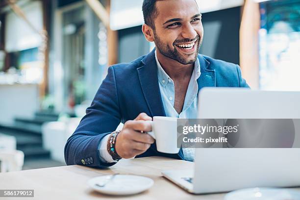 middle eastern ethnicity businessman in cafe - arab on computer imagens e fotografias de stock