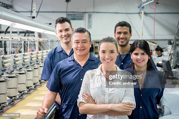 people working at an embroidery factory - textielfabriek stockfoto's en -beelden