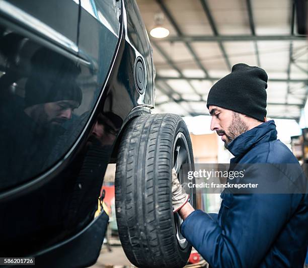 changing the tire - dismantling stock pictures, royalty-free photos & images