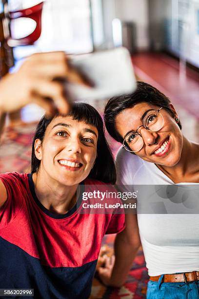 friends, young woman resting and enjoying coffee at home - cool couple in apartment stock pictures, royalty-free photos & images