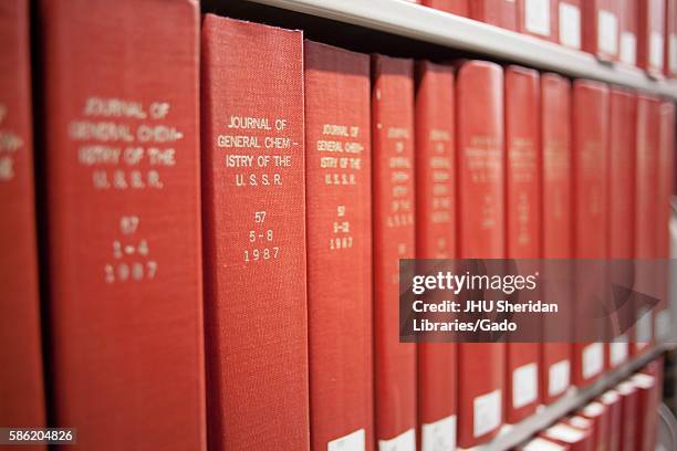 Photograph of red books on a shelf reading "The Journal of General Chemistry of the USSR in volumes", 2014. Courtesy Eric Chen. .