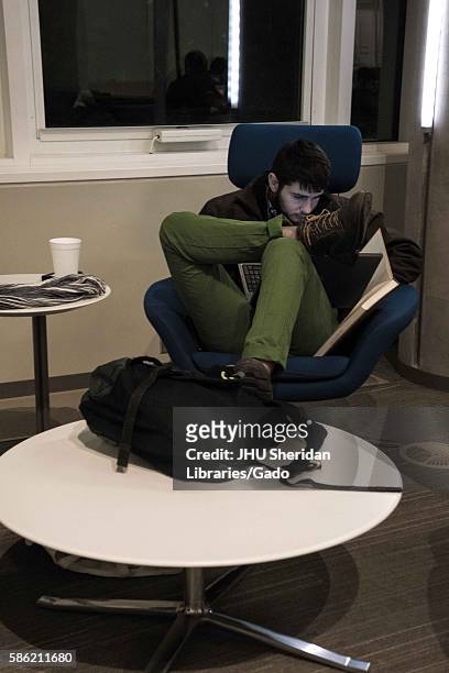 College student studies late at night in the Brody Learning Commons, a library and study space on the Homewood campus of the Johns Hopkins University...