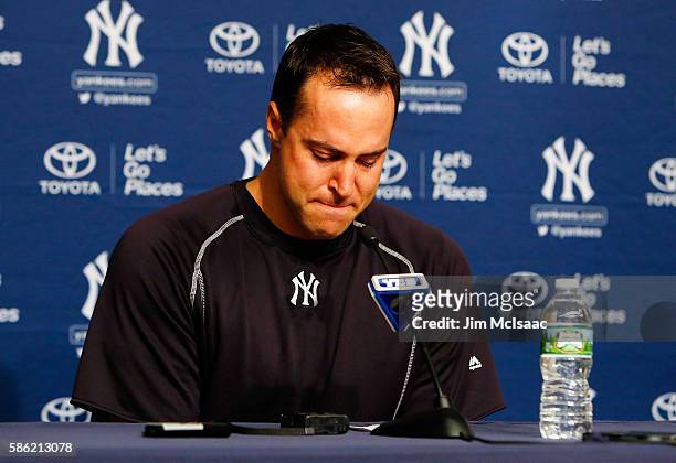 Mark Teixeira of the New York Yankees fights back tears as he announces his retirement at the end of the season during a press conference prior to...