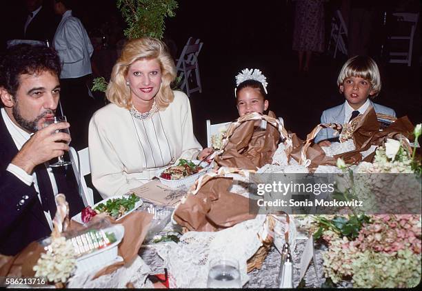 Luciano Pavarotti, Ivana Trump, Ivanka Trump and Eric Trump attend a party at the Central Park Boathouse October 1987 in New York City.