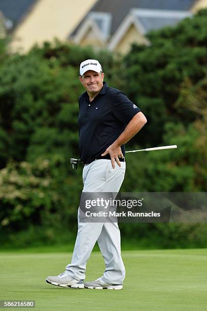 Anthony Wall of England smiles after putting on hole 15 on day two of the Aberdeen Asset Management Paul Lawrie Matchplay at Archerfield Links Golf...