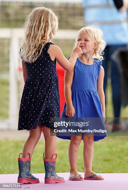 Savannah Phillips and Isla Phillips lark around as they attend day 1 of the Festival of British Eventing at Gatcombe Park on August 5, 2016 in...