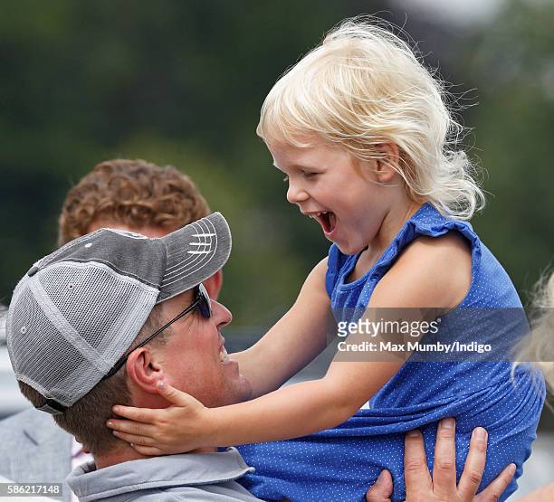 Peter Phillips and daughter Isla Phillips watch Zara Phillips compete in the dressage phase of the Festival of British Eventing at Gatcombe Park on...