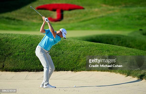 Daniel Berger of the United States plays his second shot from a bunker on the 18th hole during the second round of the Travelers Championship at the...