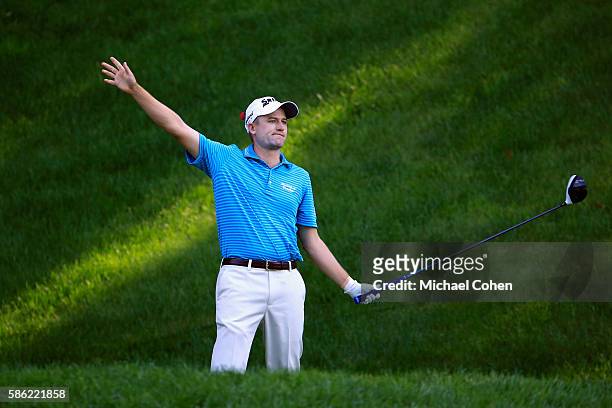 Russell Knox of Scotland reacts to his tee shot on the 15th hole during the second round of the Travelers Championship at the TPC River Highlands on...