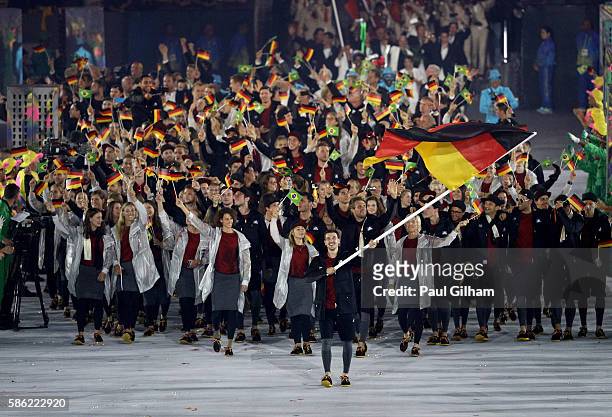 Timo Boll of Germany carries his country's flag during the Opening Ceremony of the Rio 2016 Olympic Games at Maracana Stadium on August 5, 2016 in...