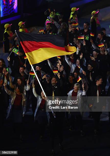 Flag bearer Timo Boll of Germany leads the Germany team during the Opening Ceremony of the Rio 2016 Olympic Games at Maracana Stadium on August 5,...