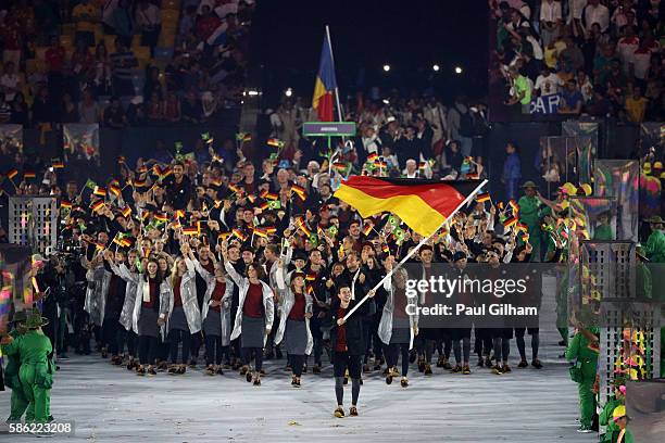 Timo Boll of Germany carries his country's flag during the Opening Ceremony of the Rio 2016 Olympic Games at Maracana Stadium on August 5, 2016 in...