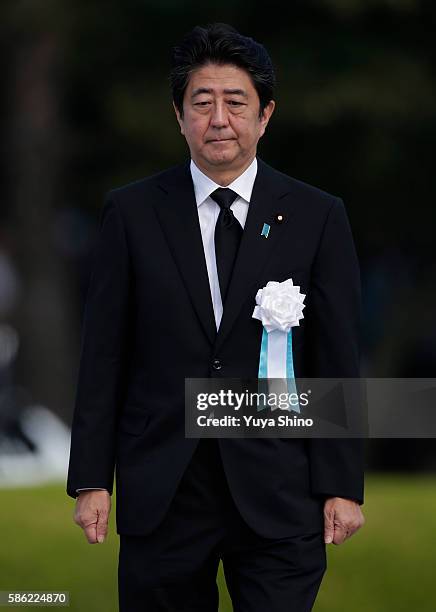 Japanese Prime Minister Shinzo Abe walks as he gives a speech during the Hiroshima Peace Memorial Ceremony at Hiroshima Peace Memorial Park on August...